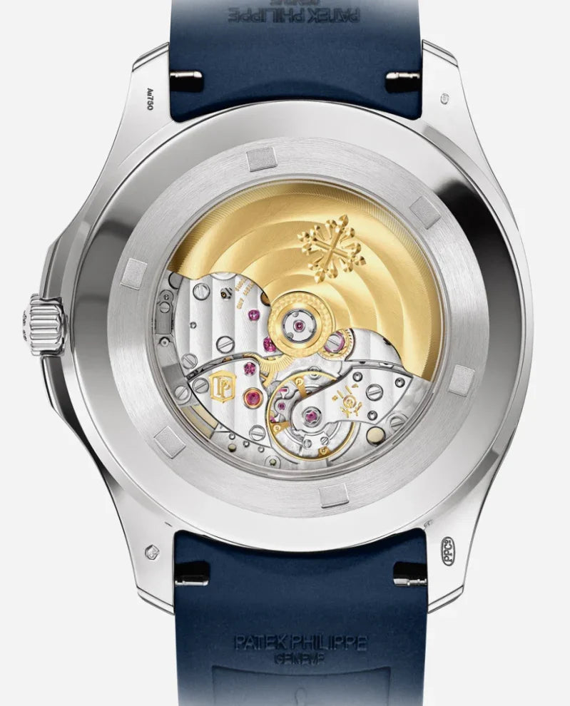 Close-up of the transparent caseback of a Patek Philippe Nautilus, revealing the detailed gold and silver automatic movement with visible gears and a blue strap.