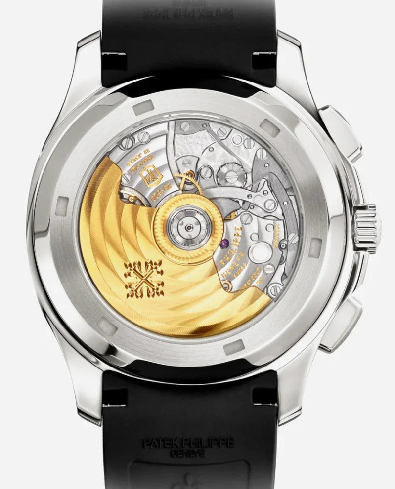 A close-up of the Relógio Patek Aquanaut reveals its detailed silver and gold-toned mechanical movement through a transparent case back, making it the perfect relógio executivo on an elegant black strap.